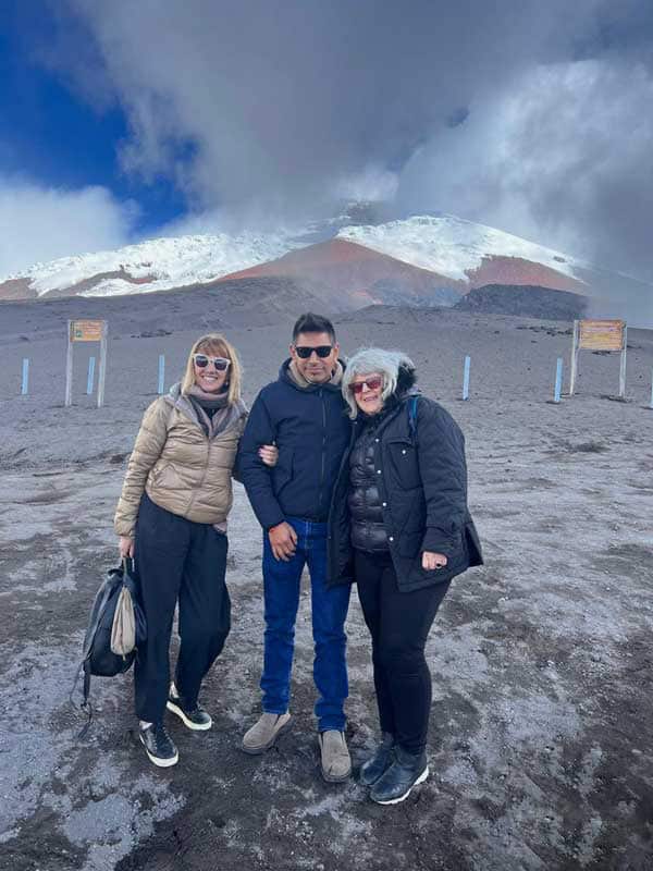 People posing on snowy mountain landscape