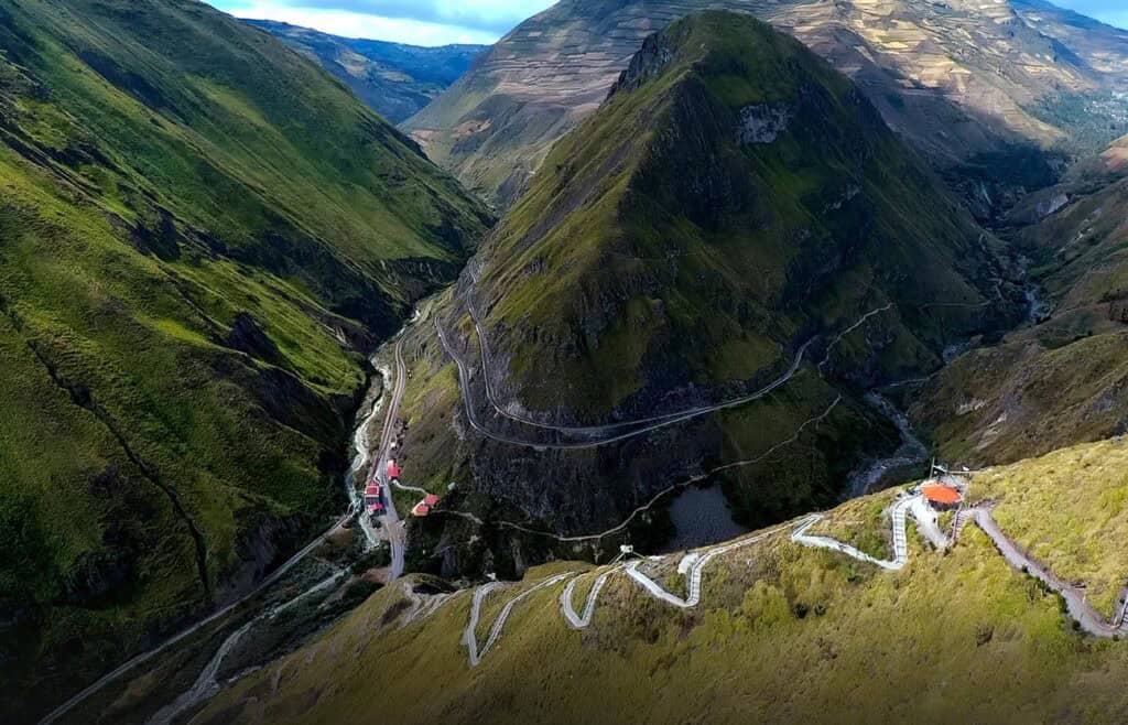 Mountain valley with winding road and green hills