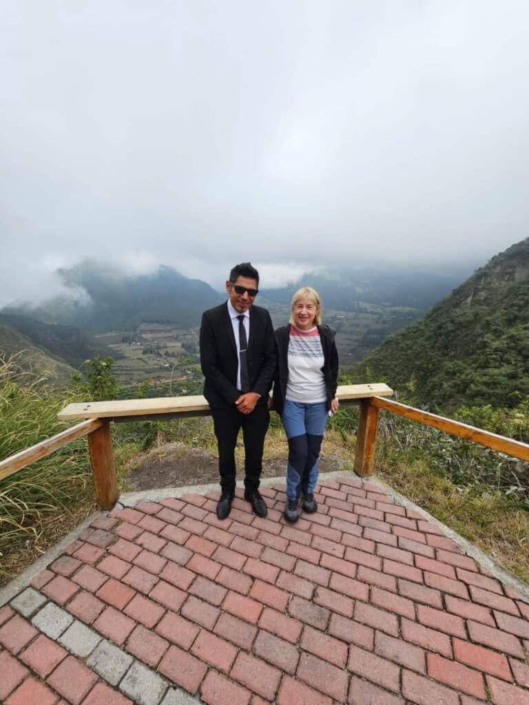 Two people standing on mountain viewpoint